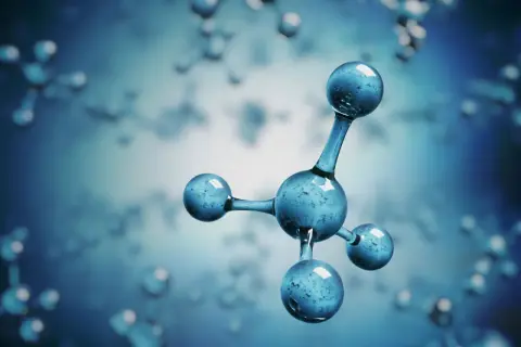 Model cząsteczki metanu, składający się z jednego centralnego atomu węgla i czterech atomów wodoru, unoszący się w niebieskim, rozmytym tle.