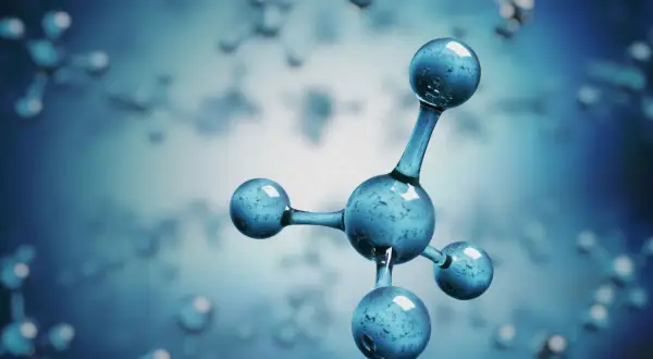 Model cząsteczki metanu, składający się z jednego centralnego atomu węgla i czterech atomów wodoru, unoszący się w niebieskim, rozmytym tle.