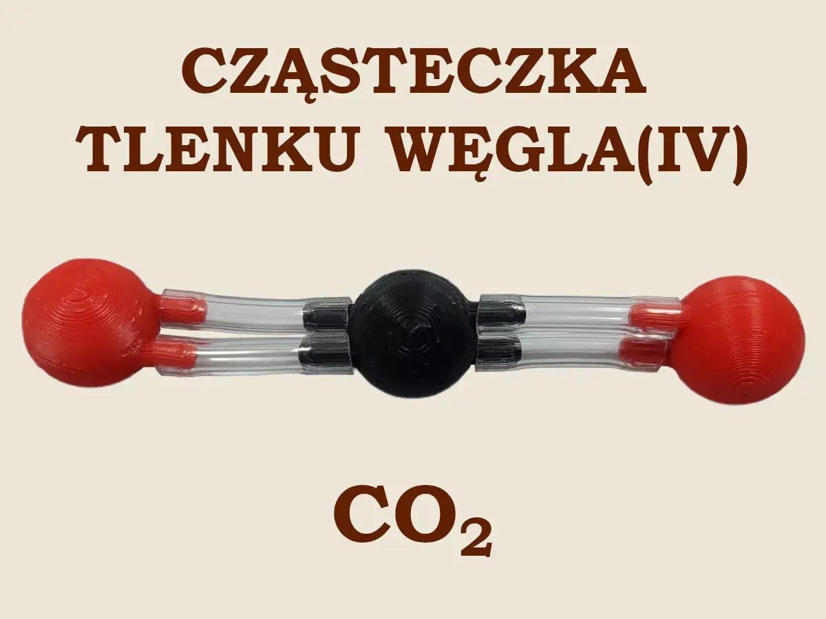 Model cząsteczki CO2. Czarny atom węgla połączony z dwoma czerwonymi atomami tlenu. Pokazuje, co2 jakie to wiązanie.